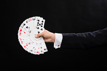 Image showing close up of magician hand holding playing cards