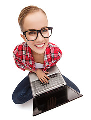 Image showing smiling teenage girl in eyeglasses with laptop