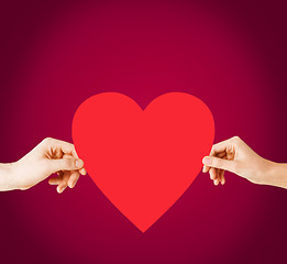 Image showing couple hands holding red heart