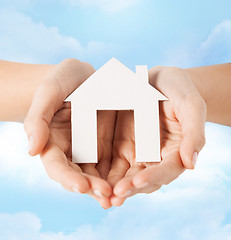 Image showing female hands holding paper house