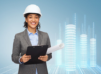 Image showing businesswoman in white helmet with clipboard