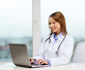 Image showing busy doctor with laptop computer