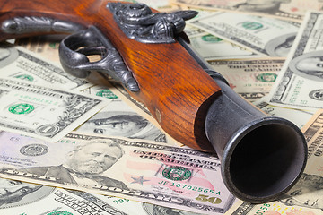 Image showing Old gun and money