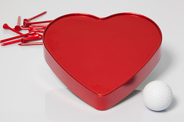Image showing Red heart and golf ball and tees