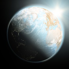 Image showing Sun rising over Earth