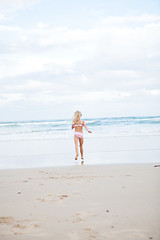 Image showing Young girl running at beach