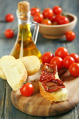 Image showing Sun-dried tomatoes on a piece ciabatta.