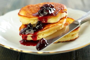 Image showing Pancakes with ricotta and cowberry sauce. 