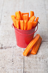 Image showing fresh sliced carrot in red bucket 