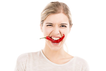 Image showing Biting a red chilli pepper