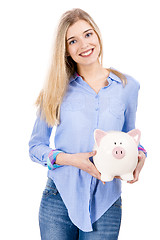 Image showing Beautiful woman holding  a piggy bank