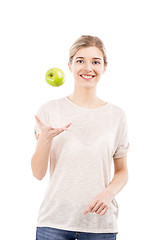 Image showing Beautiful woman throwing a green apple