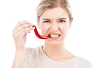 Image showing Biting a red chilli pepper