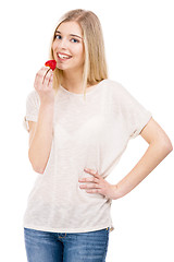 Image showing Woman tasting strawberries