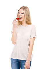 Image showing Woman tasting strawberries