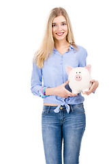 Image showing Beautiful woman holding  a piggy bank