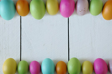 Image showing Easter or Spring Themed Background of Old Wood and Colored Eggs 