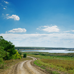 Image showing winding dirty road and blue sky