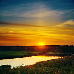 Image showing last sunrays in sky over river