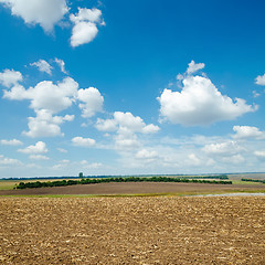 Image showing ploughed field and light clouds over it