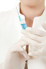 Image showing hands in rubber gloves with syringe