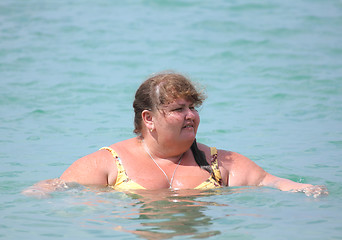 Image showing plump woman bath in sea