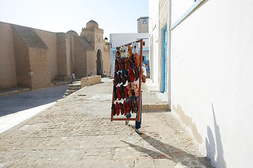 Image showing A muslim man selling shoes