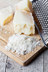 Image showing grated parmesan cheese and metal grater