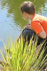 Image showing Boy sitting by the lake