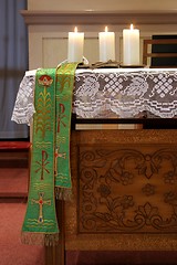 Image showing Three burning candles on church altar