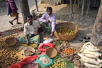 Image showing Tribal villagers bargain for vegetables. Kumrokhali, West Bengal, India