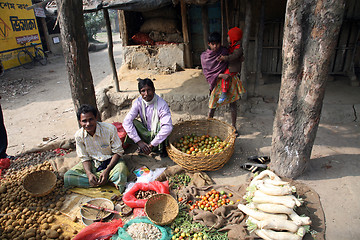 Image showing Tribal villagers bargain for vegetables. Kumrokhali, West Bengal, India