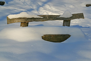 Image showing Wooden bench covered with snow