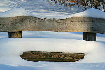 Image showing Wooden bench covered with snow