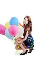 Image showing Beautiful female keeping multicolored air balloons