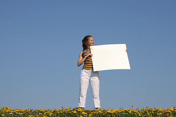 Image showing Girl holding blank banner with copy space