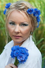 Image showing Portrait of beautiful female with blue flowers