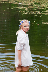 Image showing Woman standing in the water looking back