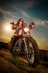 Image showing Biker girl sitting on motorcycle