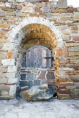 Image showing Ancient wooden window of medieval brick wall