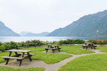 Image showing Table and benches for picnic on fjord shore
