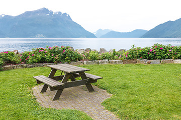 Image showing Table and benches for picnic on fjord shore