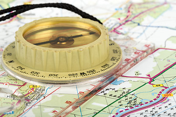 Image showing old touristic compass on map 