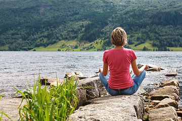 Image showing Woman relaxing at lake shore