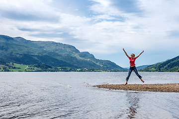 Image showing Happy young woman jumping for joy