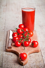 Image showing tomato juice in glass and fresh tomatoes 