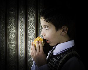 Image showing Child who eat. Vintage clothes 