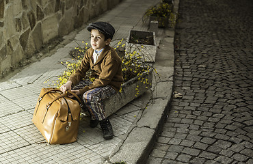 Image showing Child on a road with vintage bag