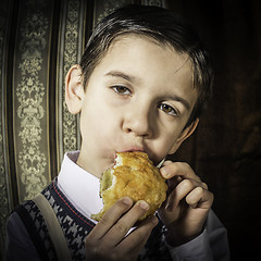 Image showing Child who eat. Vintage clothes 