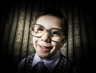 Image showing Smiling child with glasses in vintage clothes